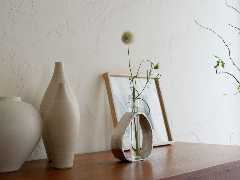 クレエのアルミガラスベースに一輪の花が美しく生けられた花瓶