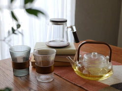 アデペシュnoonコレクションのホウケイ酸ガラスとウォールナット製ティーポットとデザインカップが美しく並べられたセット