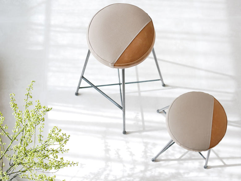 SIKAKUのtwo toneスツール。牛本革とキャンバスを使用した座面に、クリアラッカー塗装の鉄脚を組み合わせた日本製デザイン。低さ470mmまたは高さ720mmのモデル。