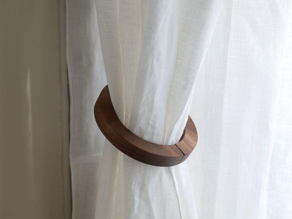 天然木製のウッドリングタッセルがカーテンに掛かっている様子