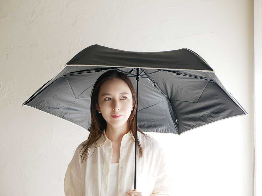 モデルがグレーのビコーズ遮光傘を持つ屋外撮影