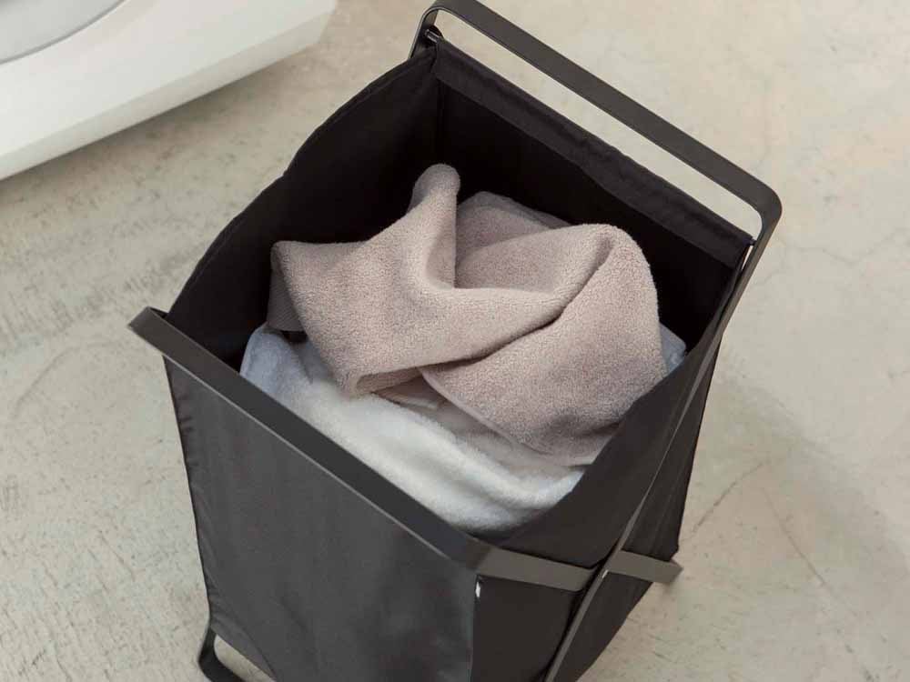 YAMAZAKI/towerブランドの灰色ランドリーバスケット。スチールフレームとプラスチックバスケット、持ち運び用ハンドル付き