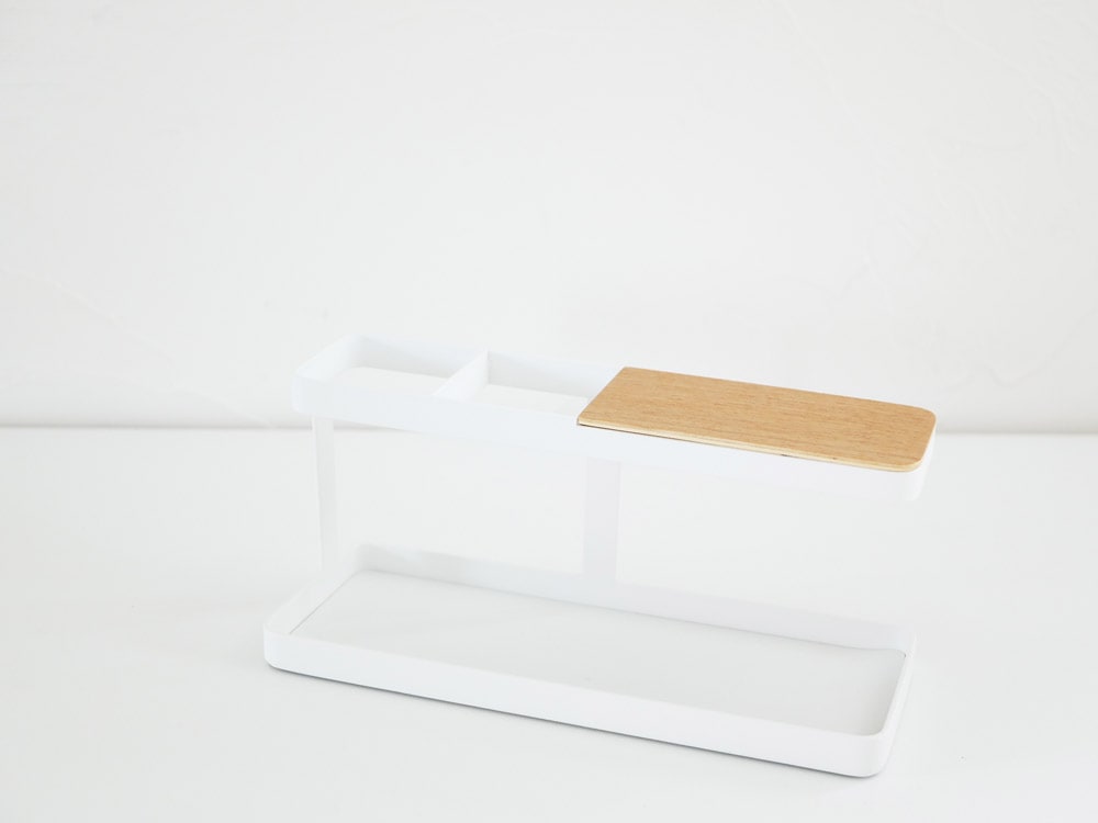 YAMAZAKI/towerブランドのデスクバー。スチールと天然木積層合板製で、プラスチック製のトレイと蓋が付いたオフィス用品がデスク上に配置されています。