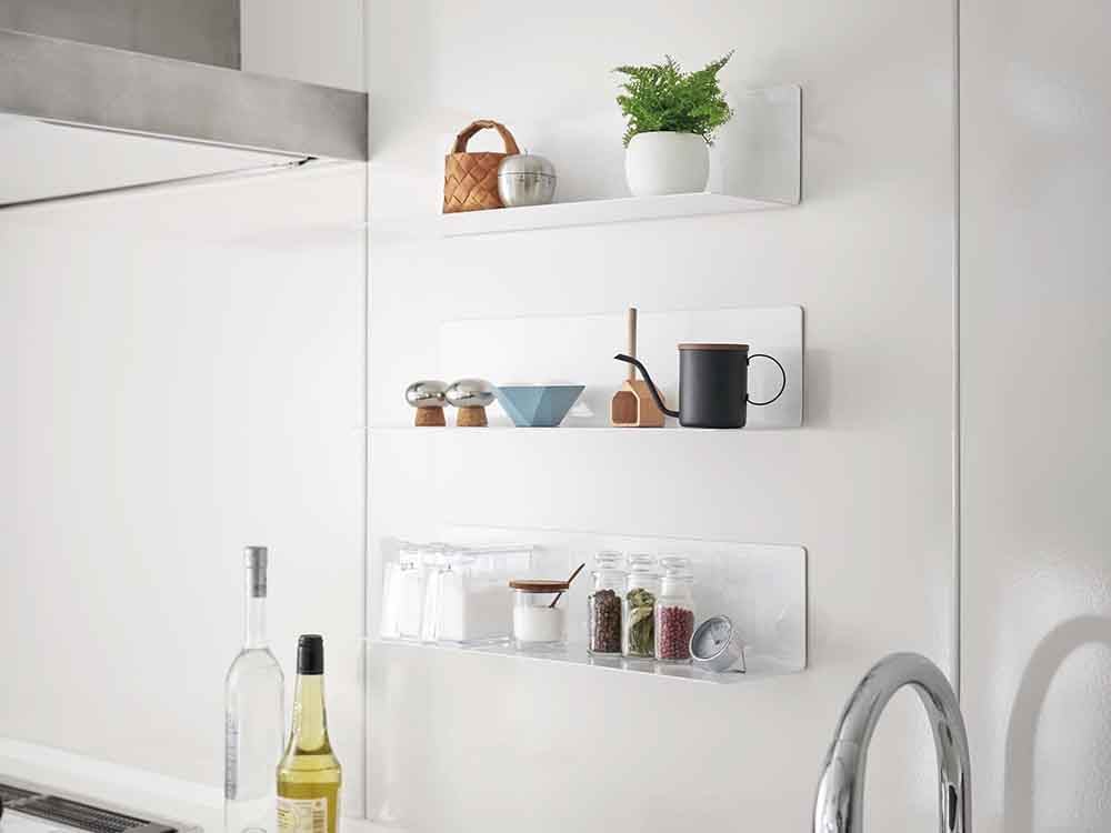 マグネットキッチン棚に並べられた食器とボトル