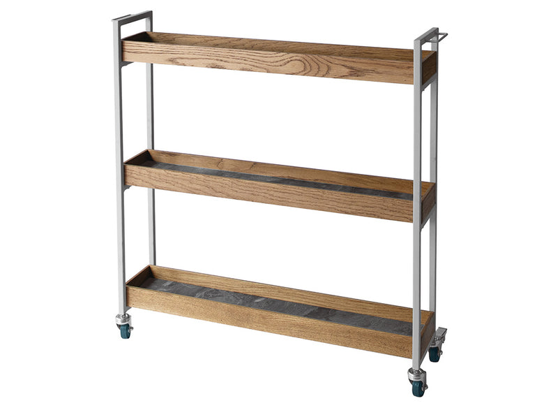 アデペシュのPOLムービングワゴンがキッチンの棚やキャビネットと共に配置され、引き出しやフルーツが置かれている様子