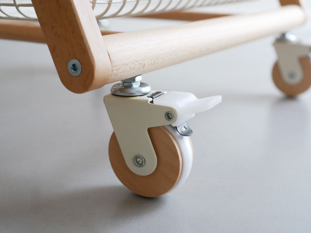 天然木製のマッシュリヴテーブルワゴンがベビーベッドとバシネットの隣に配置されている様子