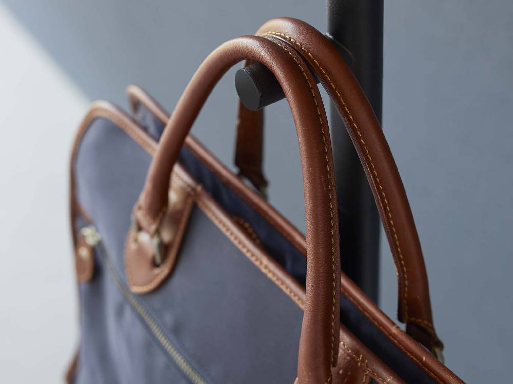 茶色のレザー製ビジネスバッグとブリーフケース、金属製ストラップ付きの手提げ荷物