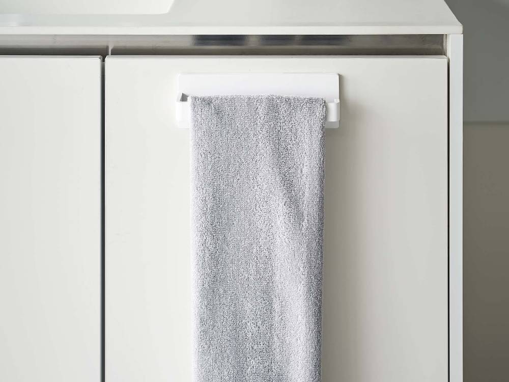 浴室の洗面台横に設置された【MIST/ミスト】フィルムフック タオルハンガー W18にタオルや食器用布巾が掛けられている様子