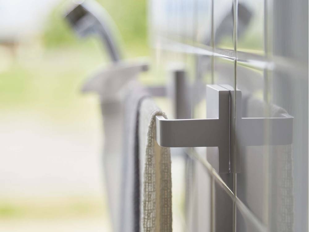 浴室のタイル張りの壁に設置された【MIST/ミスト】フィルムフック タオルハンガー W36にタオルが掛けられている様子。