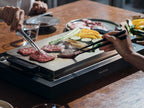 BALMUDA The Plate ProとTakoyaki Plateを使い、食材と調理器具が並ぶキッチンでたこ焼きを調理している様子