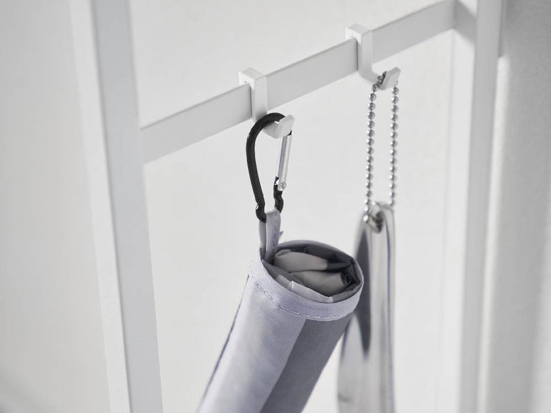 シルバーのロープで吊るされた服掛けと服馬が配置されたソファー裏コンソールテーブル