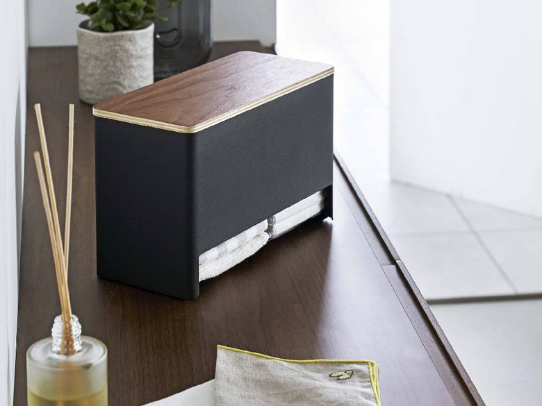 スチールと天然木積層合板で作られた分別サニタリー収納ホルダーが、オフィス用品やガジェットとともに配置されている様子