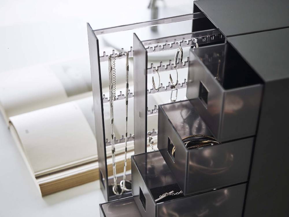 シルバーのタワー型ネックレス＆ピアス収納ケース。複数の引き出しと棚があり、アクセサリーを整理できるデザイン