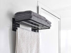 マグネットバスタオル棚が浴室のスチール壁に取り付けられ、タオルやリネンが整然と掛けられている様子。