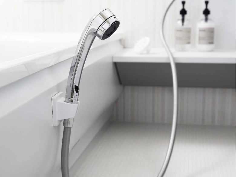 バスルームに取り付けられたシルバー製【MIST/ミスト】フィルムフックシャワーホルダー。蛇口や配管と共に配置されている