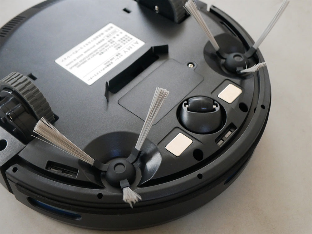 黒色のAiMY自動充電式ロボットクリーナーが充電ステーション上に置かれている様子