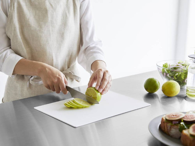 タワー抗菌シートまな板の上に果物や野菜、包丁などの食材とキッチン用品が整然と配置された調理シーン