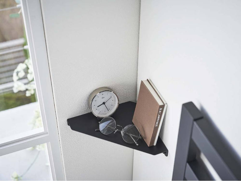 スチール製の銀色コーナーシェルフ『tower』が石こうボードの壁に設置されている様子