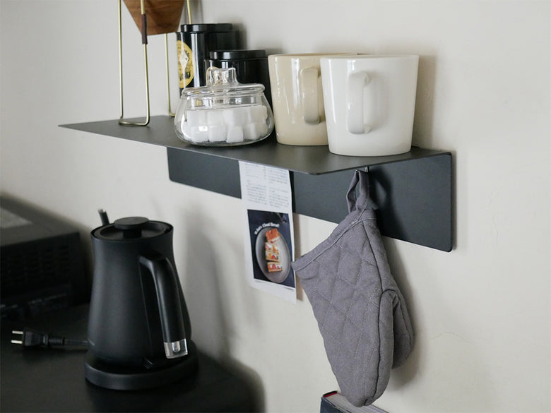 マグネット付きウォールラックにカップやマグが飾られているキッチン用品の棚