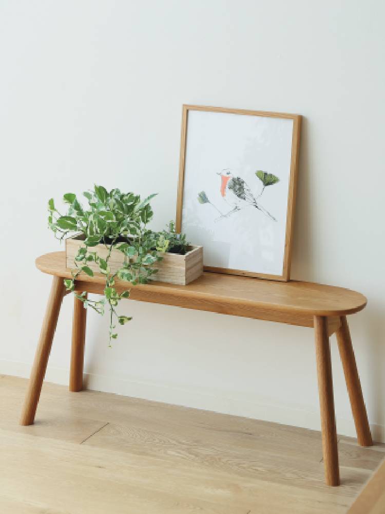 高野木工のホワイトオーク製RUBEワイドスツールが花鉢とともに屋外に配置された様子