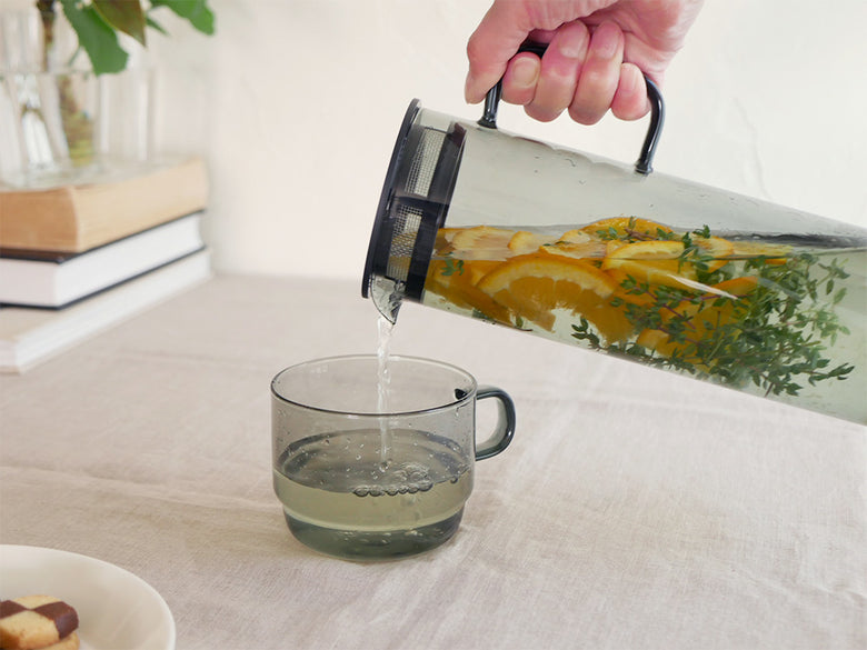 ハリオの耐熱ガラス製コールドブリューピッチャーとスタックマグカップが並んだテーブルセット