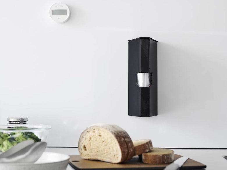 スチールとマグネットで作られた『tower』マグネットプラスチックバッグケースが平らな壁面に取り付けられており、プラスチックバッグを整理整頓している様子