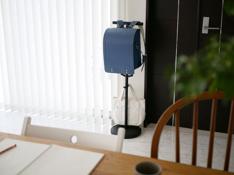 スマートブランドのランドセルスタンドと電気ケーブルや照明器具が配置された室内の静物写真